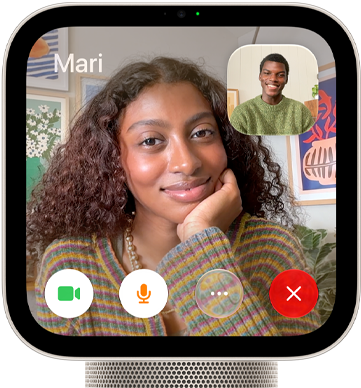 Apple HomeView, starlight (pale gold) colour, front exterior, showing a FaceTime video call screen displaying one person in the main view and another person in an inset window, with control buttons at bottom of screen
