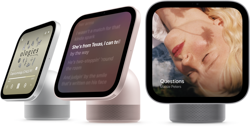 Apple HomeView, three devices all displaying Apple Music app album artwork and lyrics, from left to right, silver colour, side exterior, rose pink colour, side exterior, space grey colour, front exterior