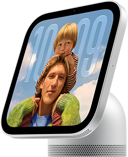 Apple HomeView, silver colour, side exterior, semi-transparent time of day displayed on an image of a person carrying a child on shoulders, both looking forward