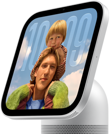 Apple HomeView, silver colour, side exterior, semi-transparent time of day displayed on an image of a person carrying a child on shoulders, both looking forward