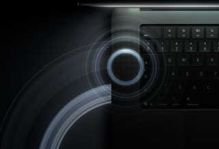 MacBook Pro with PROLED XDR Display, open lid, space black colour, keyboard lit by glow from display, circles depicting sonic waves emanate from top and left side of laptop body