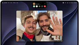 MacBook Pro with PROLED XDR Display, silver colour, display shows a video call in progress with two people in a sunlit town waving to a person at home