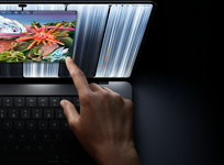 MacBook Pro with PROLED XDR Display, space black colour, user resizes a window on screen with their fingertip